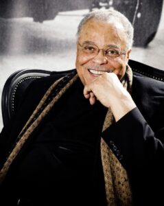 Picture of James Earl Jones sitting with a big smile.