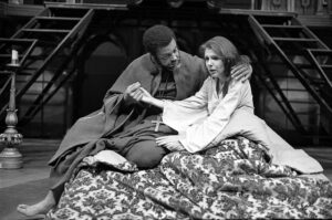 A younger James Earl Jones acting with a female actor in a Broadway style show.