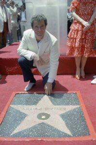 William Shatner kneeling in front of his Hollywood star.