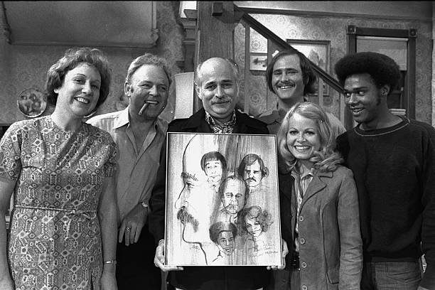 Norman Lear posing with cast of All in the Family.