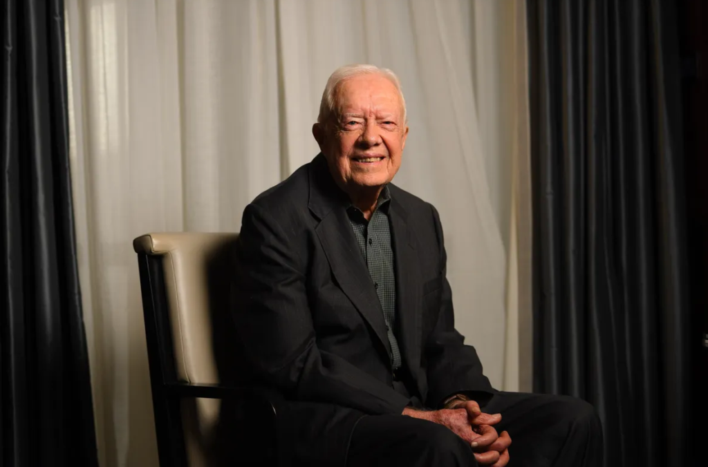 A younger Jimmy Carter sitting for a  picture.