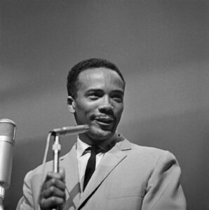 A young Quincy Jones at the microphone.