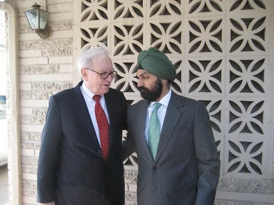 Warren Buffet syanding with another business person.