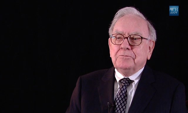 A picture of Warren Buffet where he appears to be seriously listening.